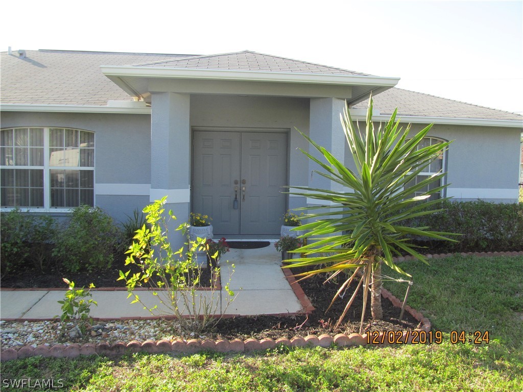 17532 Butler Road Fort Myers, FL 33967 - Photo 3 of 29 a front view of a house with a yard
