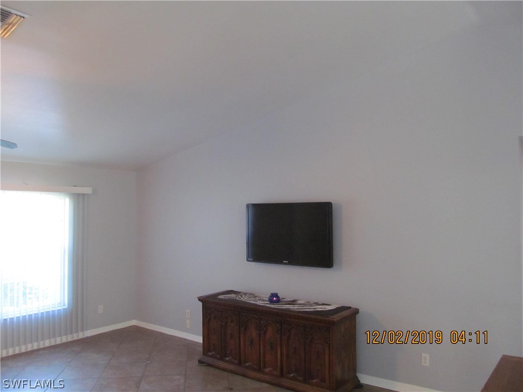 17532 Butler Road Fort Myers, FL 33967 - Photo 8 of 29 a living room with furniture and a flat screen tv
