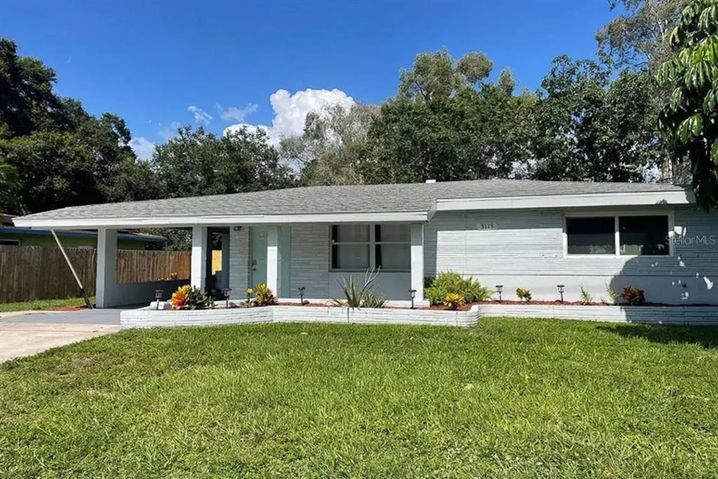 3113 McIntosh Road Sarasota, FL 34232 - Photo 1 of 22 a front view of house with outdoor seating and yard