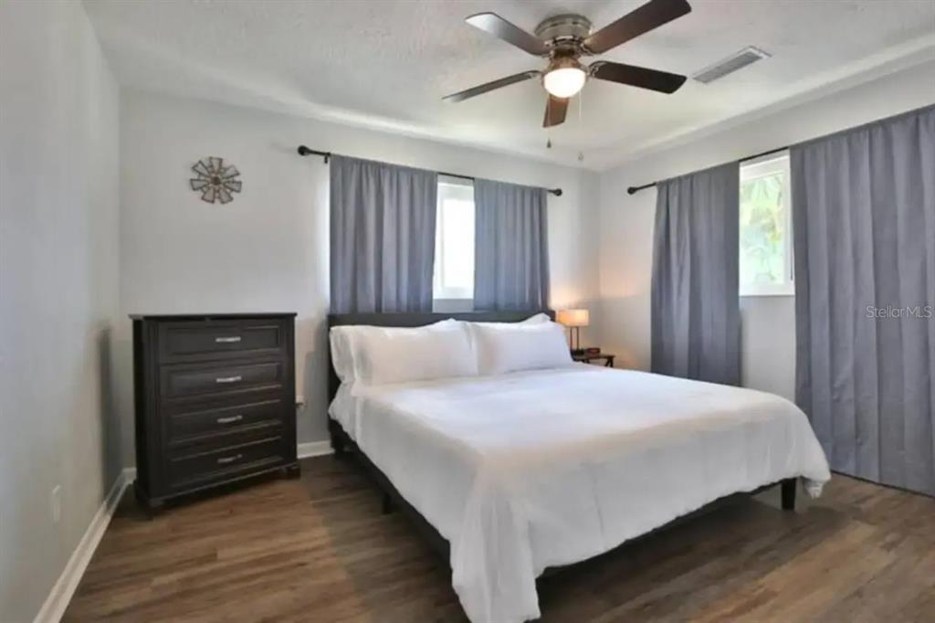 3113 McIntosh Road Sarasota, FL 34232 - Photo 13 of 22 a bedroom with a bed and a ceiling fan