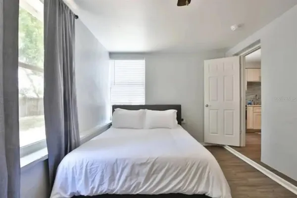 a bedroom with a bed and a window