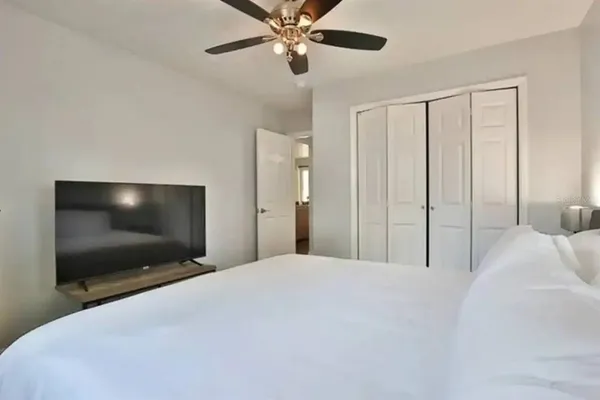 a bedroom with a bed and a flat screen tv