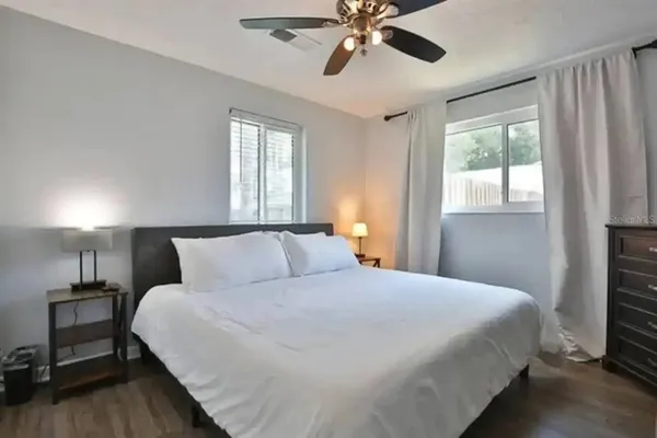 a bedroom with a large bed and a window