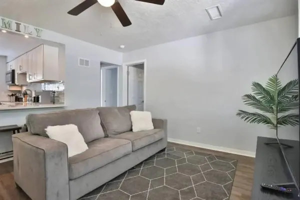 a living room with furniture and a potted plant