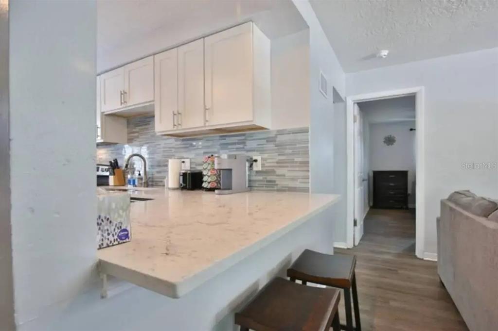 3113 McIntosh Road Sarasota, FL 34232 - Photo 20 of 22 a kitchen with stainless steel appliances granite countertop a sink refrigerator and cabinets