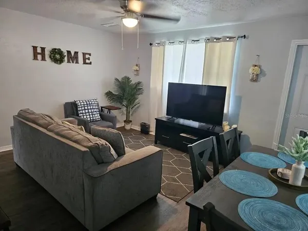 a living room with furniture and a flat screen tv