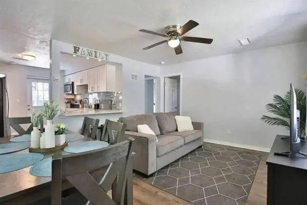 a living room with furniture and kitchen view
