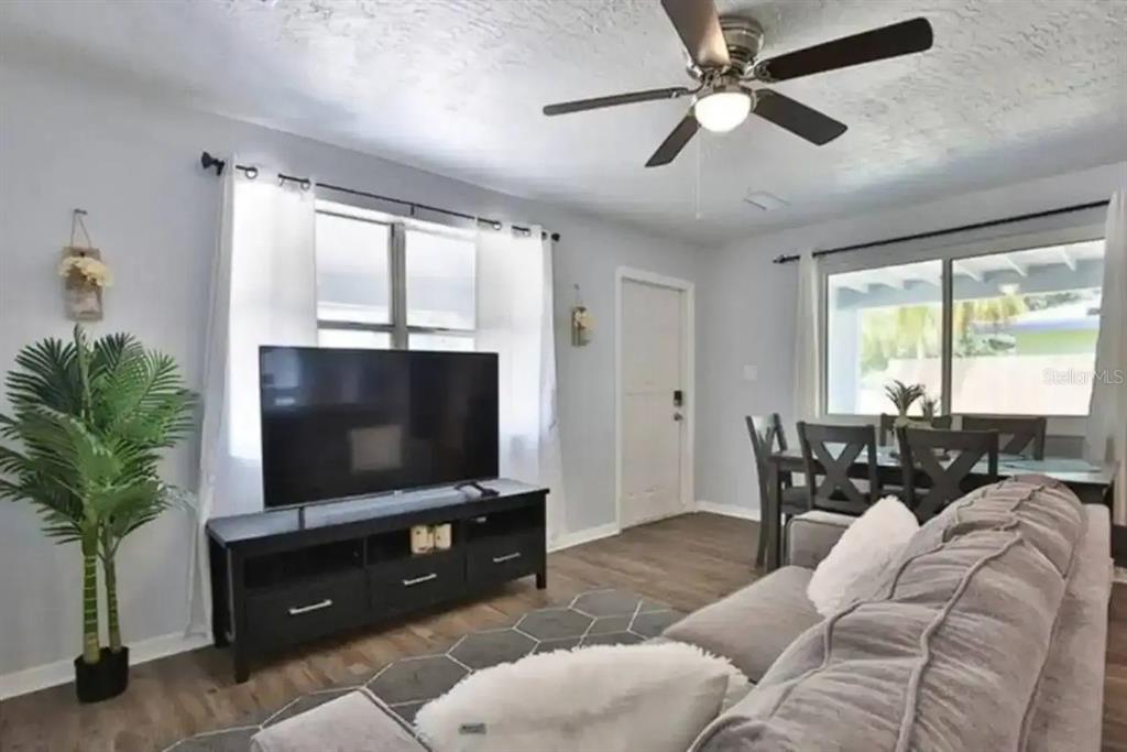 3113 McIntosh Road Sarasota, FL 34232 - Photo 8 of 22 a living room with furniture and a flat screen tv