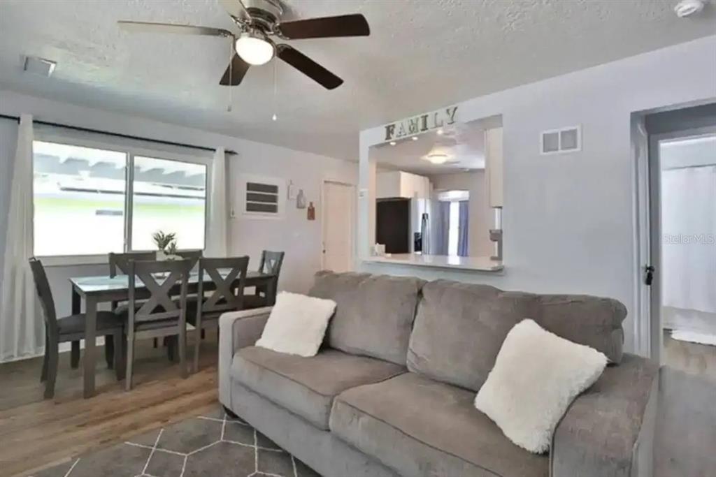 3113 McIntosh Road Sarasota, FL 34232 - Photo 9 of 22 a living room with furniture kitchen view and a large window