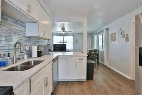 a kitchen with cabinets a sink and appliances