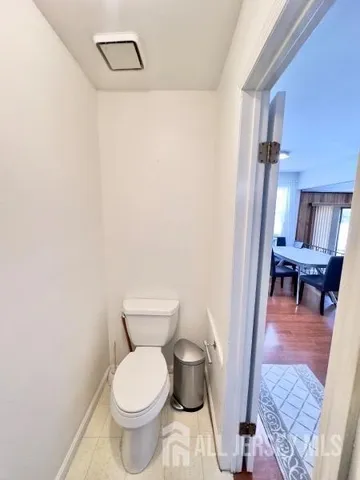 a bathroom with a toilet and a mirror