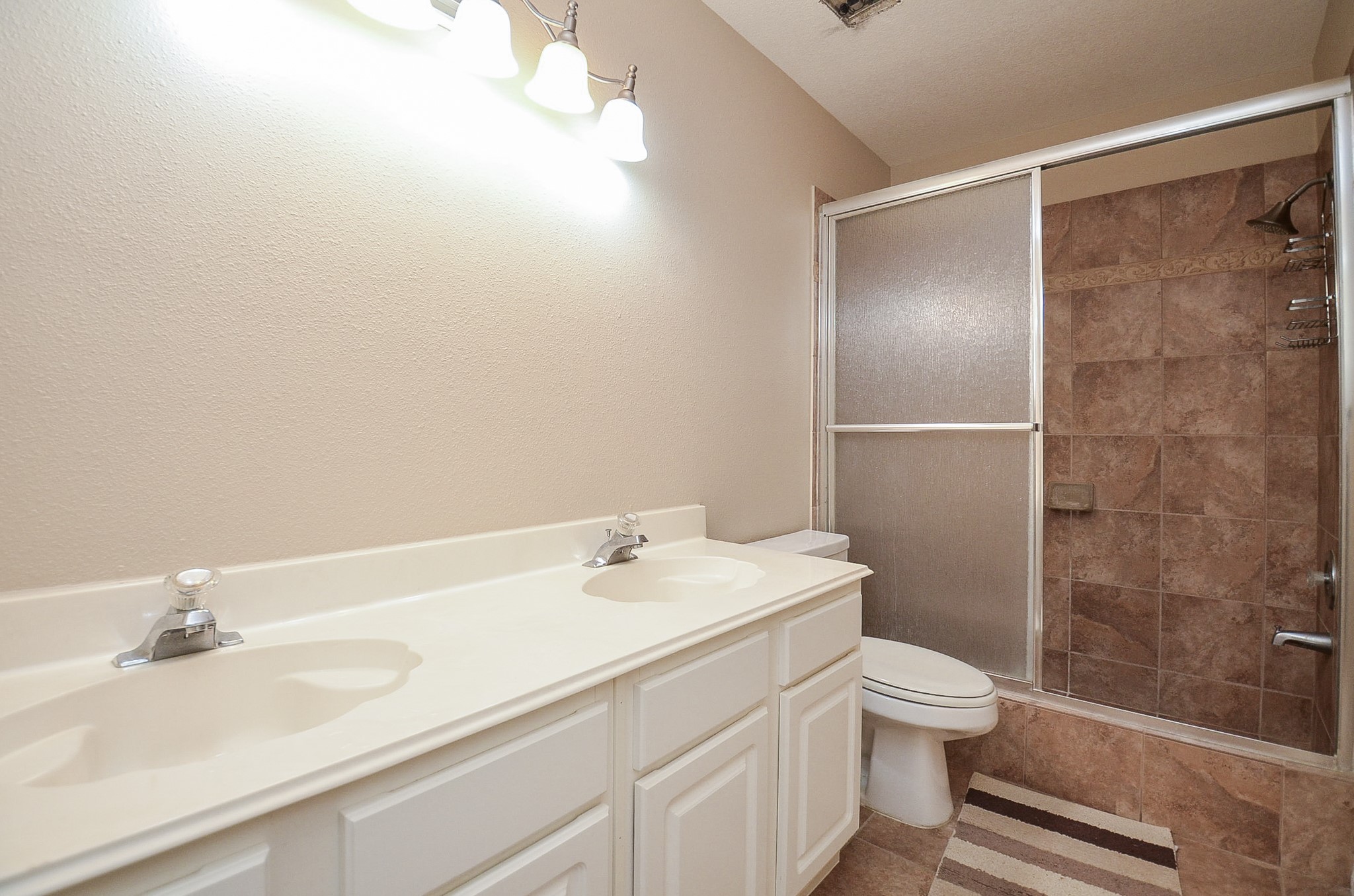 8803 Tweedbrook Drive Spring, TX 77379 - Photo 24 of 36 Step into this beautiful bathroom with a glass door enclosed shower/tub combination and double sinks.