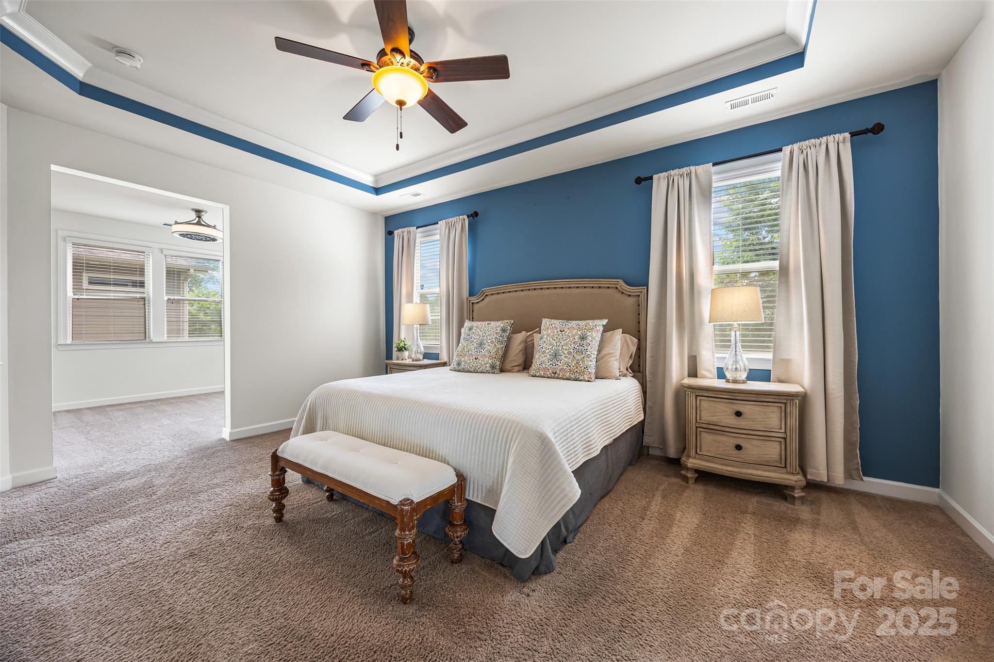 1284 Independence Street Fort Mill, SC 29708 - Photo 14 of 34 a bedroom with a large bed and a chandelier fan