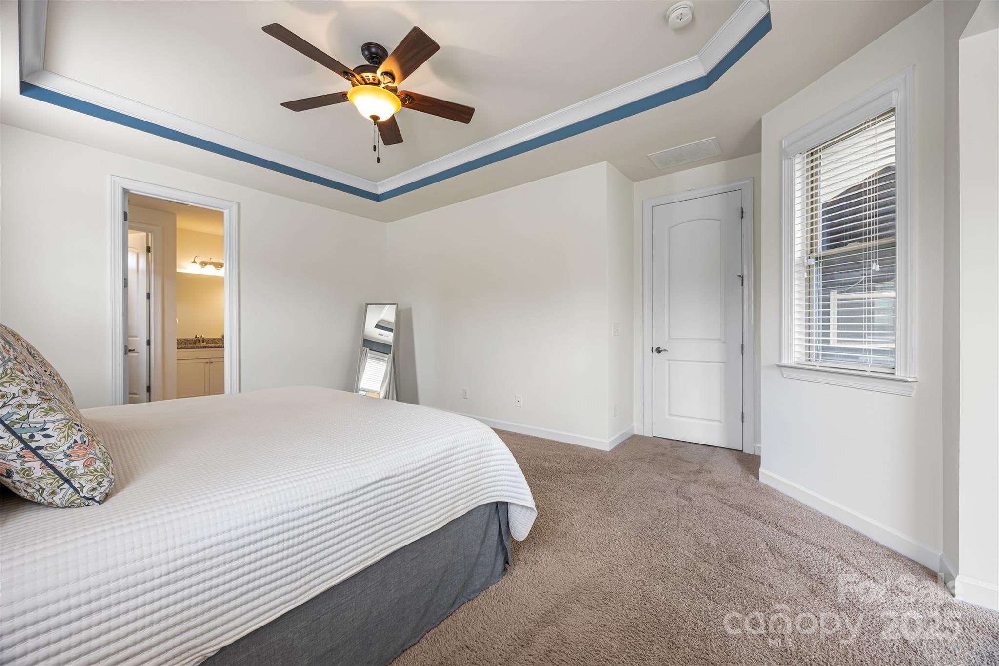 1284 Independence Street Fort Mill, SC 29708 - Photo 15 of 34 a bedroom with a bed and a chandelier fan