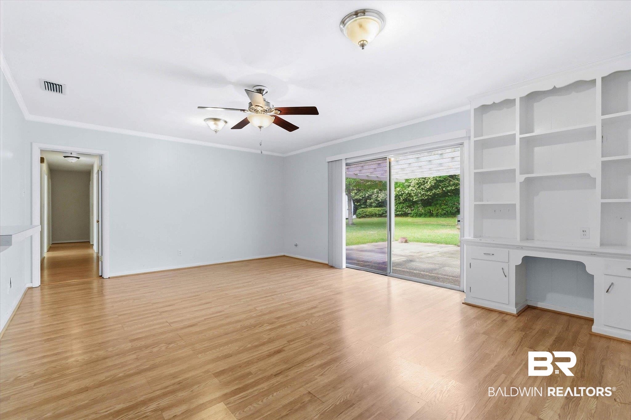 1182 Ginger Drive Mobile, AL 36693 - Photo 15 of 37 Living area featuring wood-finish flooring, a ceiling fan with integrated lighting, and crown molding