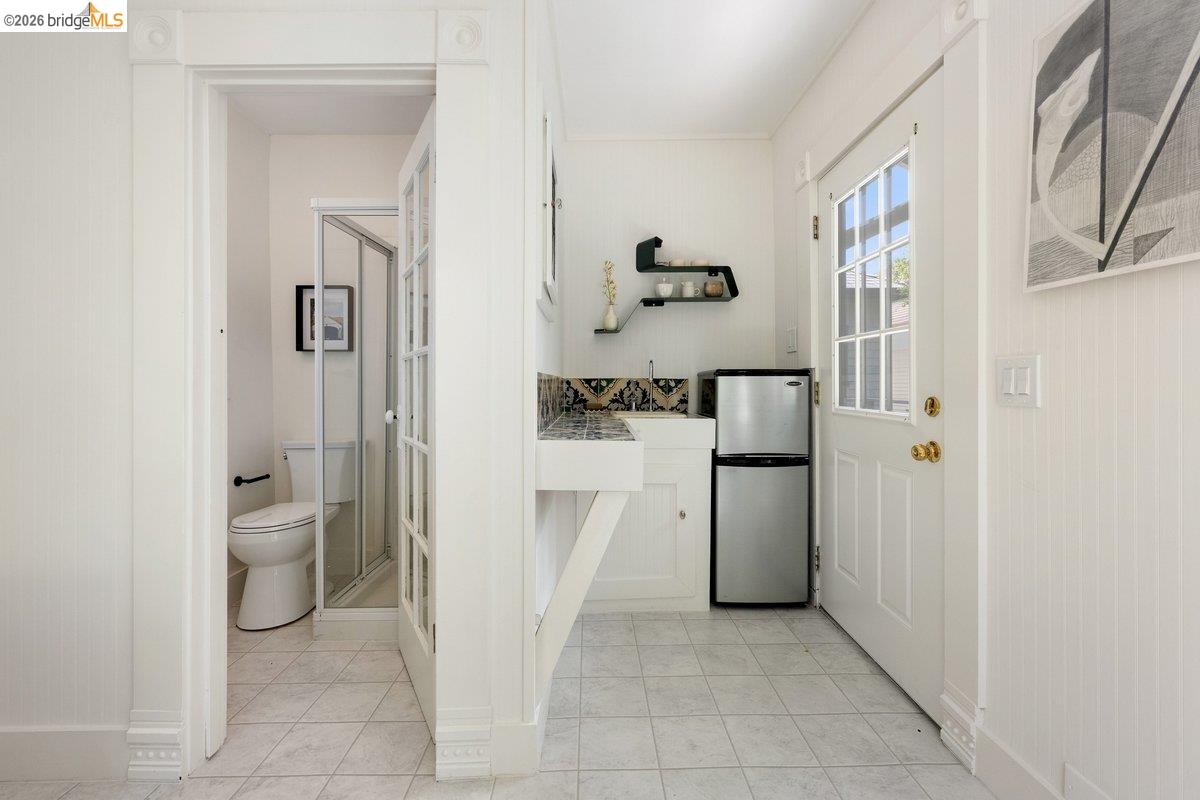 4369 Howe Street Oakland, CA 94611 - Photo 32 of 38 a bathroom with a refrigerator and a sink