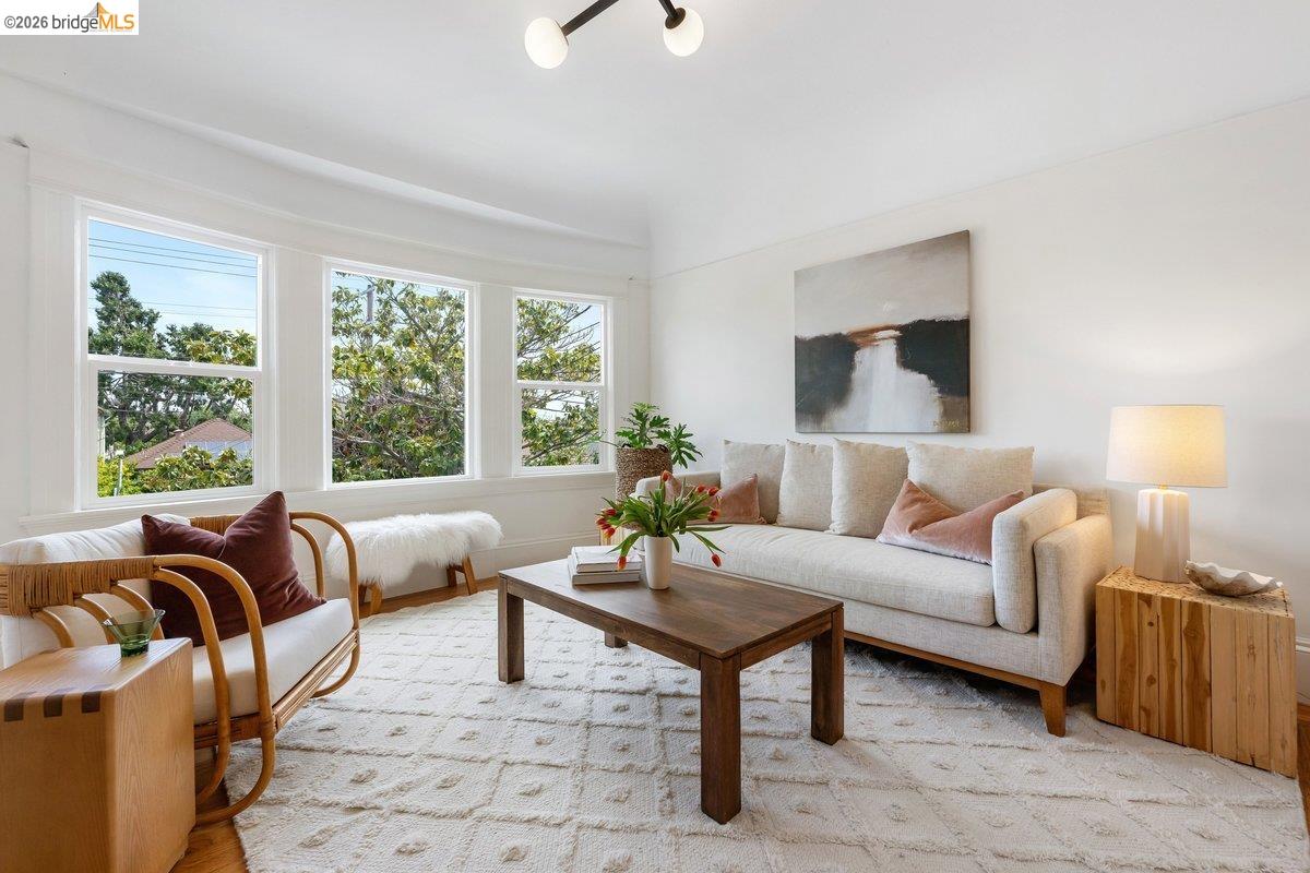 4369 Howe Street Oakland, CA 94611 - Photo 6 of 38 a living room with furniture and a large window