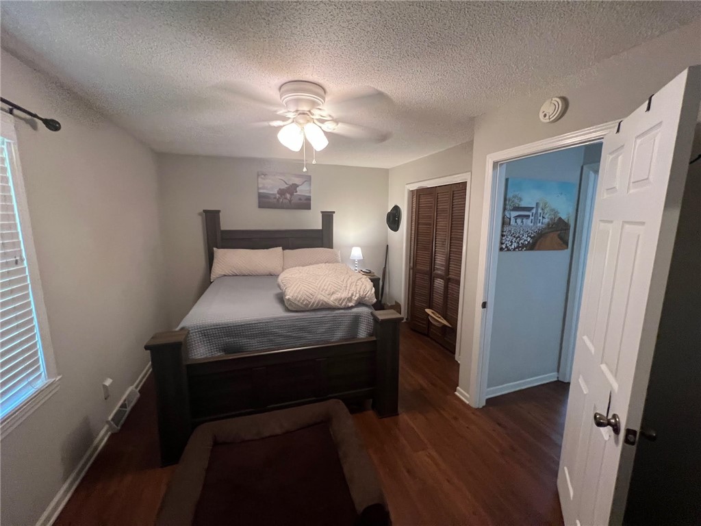 520 Ravenel Circle Seneca, SC 29678 - Photo 4 of 6 Well-lit sleeping quarters with rich hardwood flooring and a functional ceiling fan.