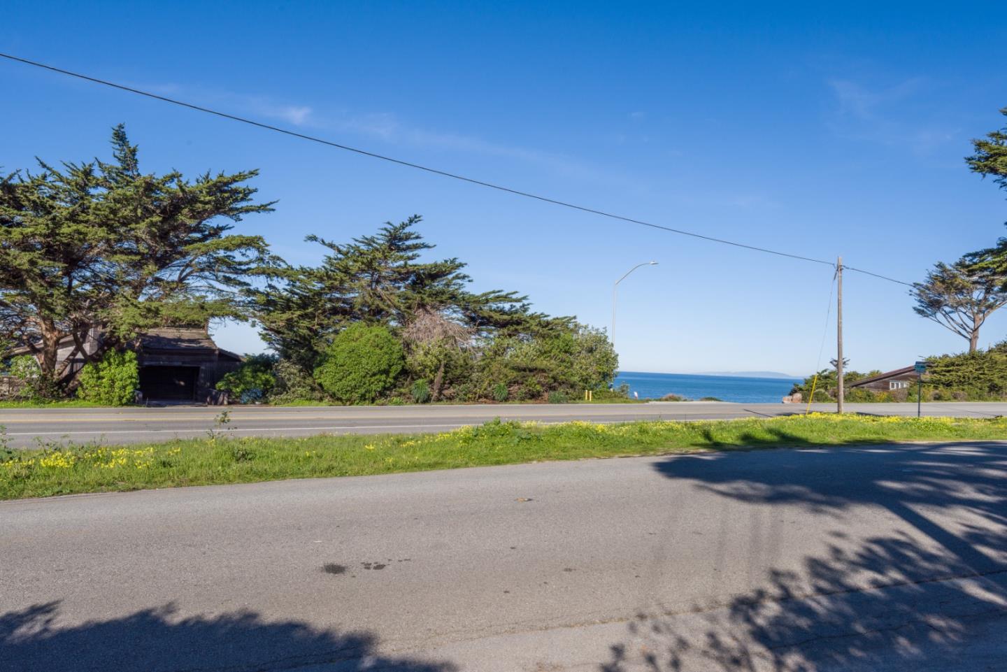 0 Main Montara, CA 94037 - Photo 4 of 12 a front view of a house with a yard and garage
