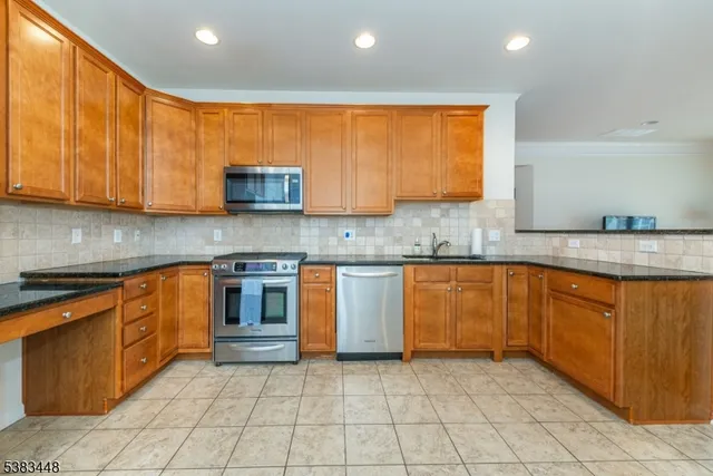a kitchen with granite countertop cabinets and stainless steel appliances