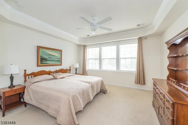 a bedroom with a bed furniture and a large window