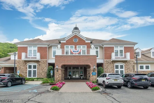 a front view of a house with a parking space