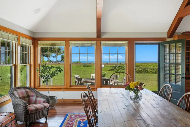 a living room with furniture and floor to ceiling windows