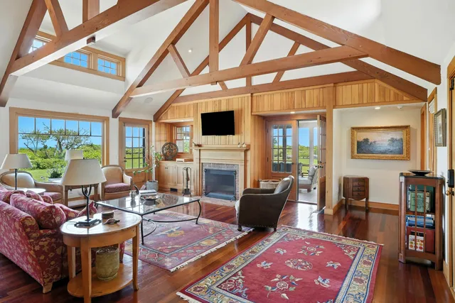 a living room with furniture a flat screen tv and a rug