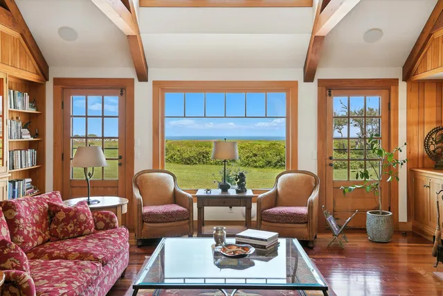 a living room with furniture rug and window