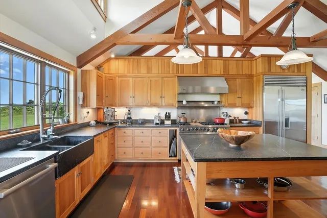 a kitchen with a stove a sink and a refrigerator