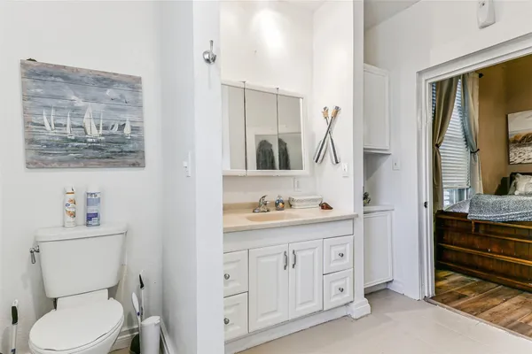 a bathroom with a toilet sink and mirror