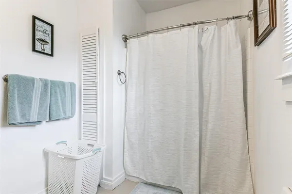 a bathroom with a shower curtain and a sink