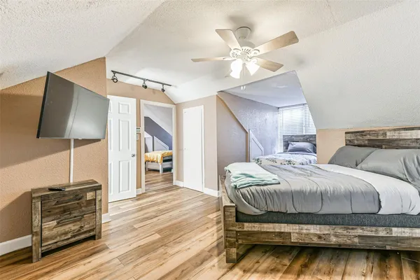 a bedroom with a bed and a flat screen tv