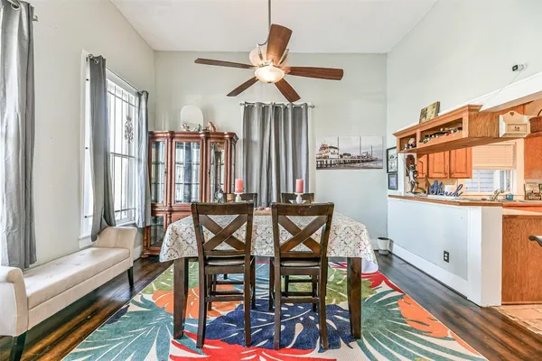 a dining room with furniture a chandelier and wooden floor