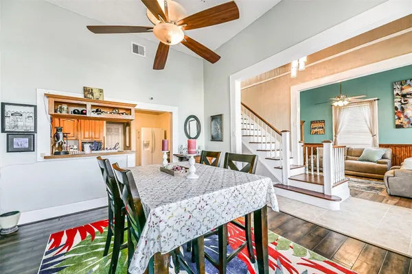 a dining room with furniture a rug and wooden floor