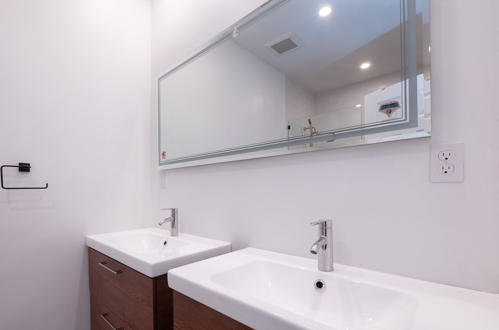 11 Wayne Street Boston, MA 02121 - Photo 11 of 27 a bathroom with a sink and a mirror