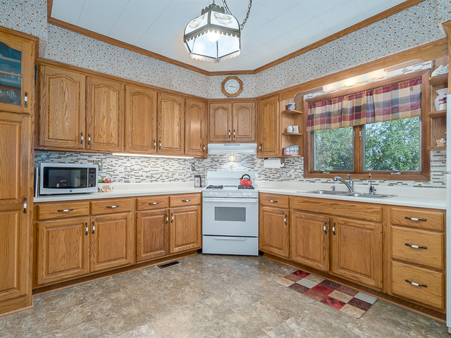 17447 West 2000N Road Reddick, IL 60961 - Photo 11 of 37 a kitchen with granite countertop a sink stainless steel appliances and cabinets