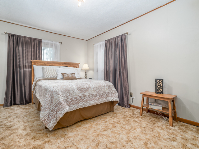17447 West 2000N Road Reddick, IL 60961 - Photo 18 of 37 a bed sitting in a bedroom next to a window and a chair