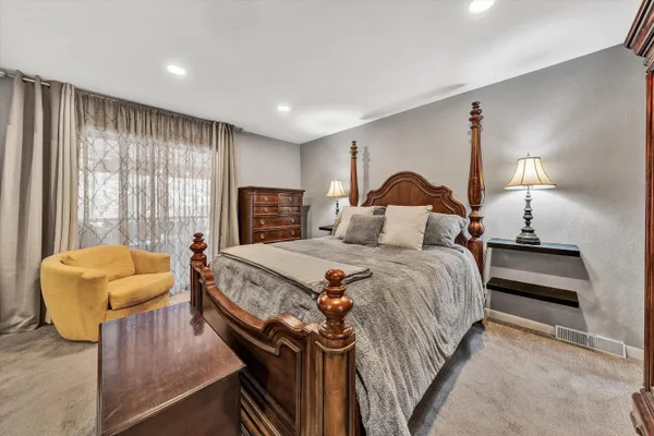 a bedroom with bed and a couch