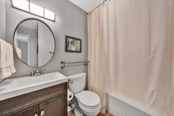 a bathroom with a toilet a sink and a mirror