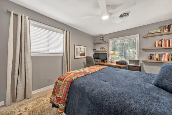 a bed room with a bed and a book shelf
