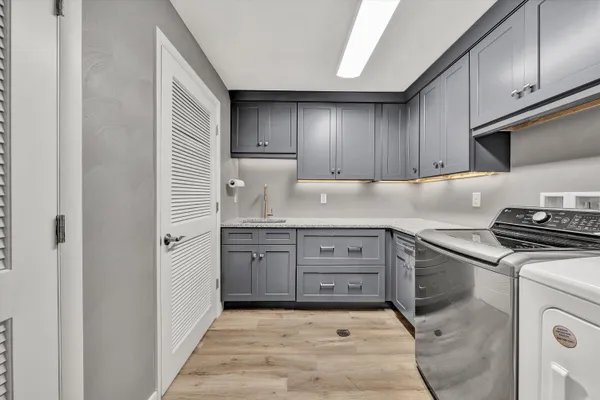 a kitchen with granite countertop a sink and a stove top oven