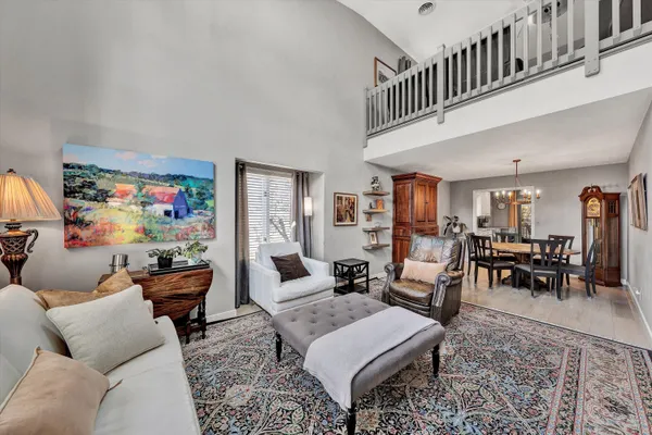 a living room with furniture and a dining table