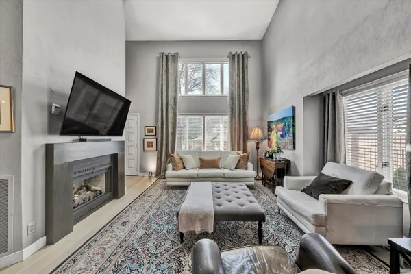 a living room with furniture a flat screen tv and a fireplace