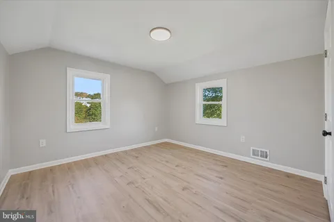 a bathroom with a double vanity sink a mirror and a bathtub