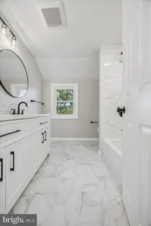 a bathroom with a double vanity sink mirror and a mirror