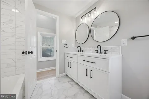 a bathroom with a toilet and a bath tub