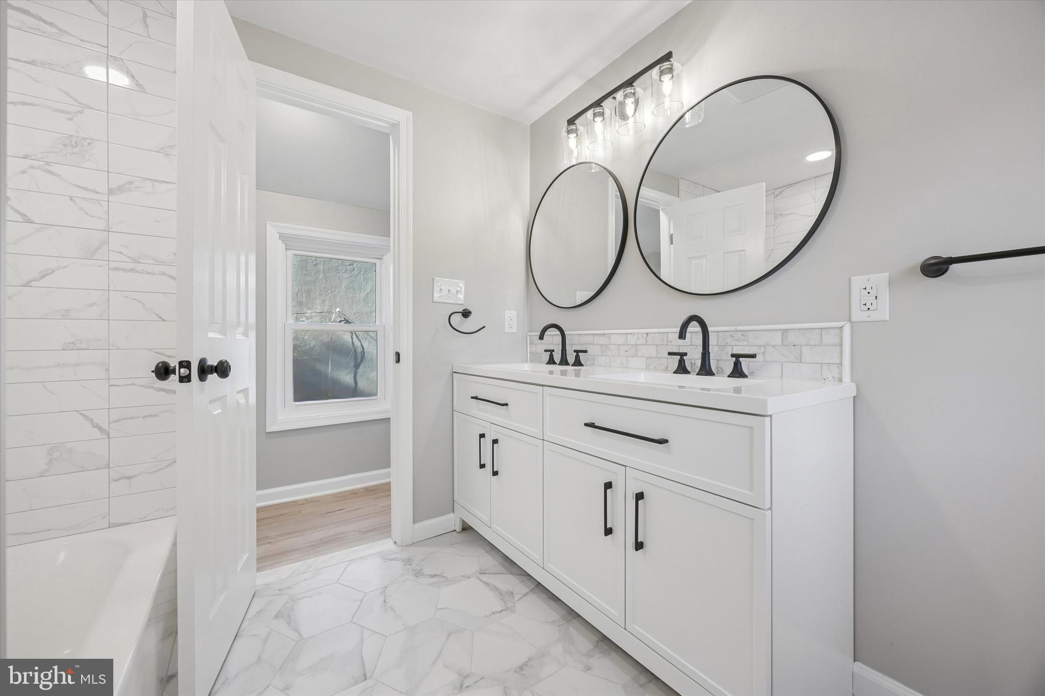 3011 Church Road Lafayette Hill, PA 19444 - Photo 21 of 30 a bathroom with a double vanity sink mirror and a mirror