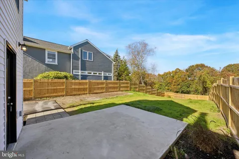 a view of a white house with yard