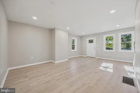 a open kitchen with a refrigerator and a sink